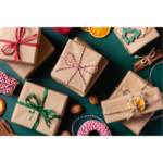 Image of presents wrapped in brown paper with red and green ribbon and a dark green background for Favorite Things Party blog post.