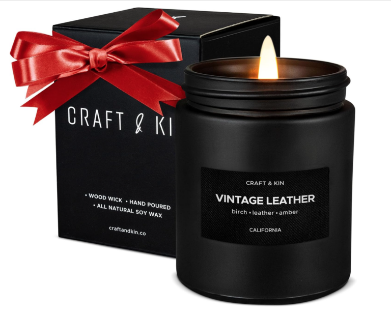 Image of candle in black container with label that says "vintage leather".