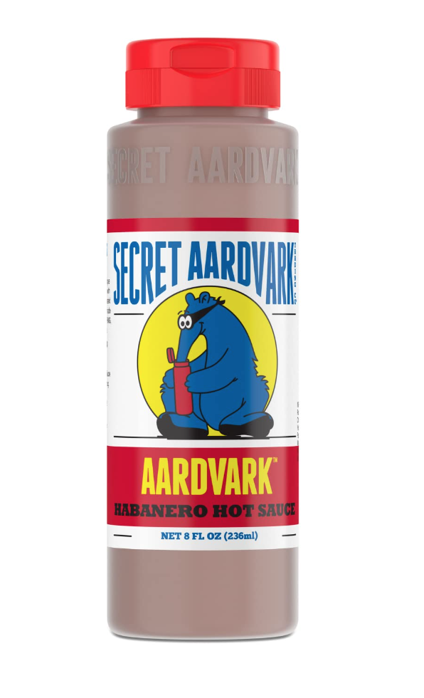 Basic household essentials. Image of Secret Aardvark habanero hot sauce. Label has a blue aardvark.
