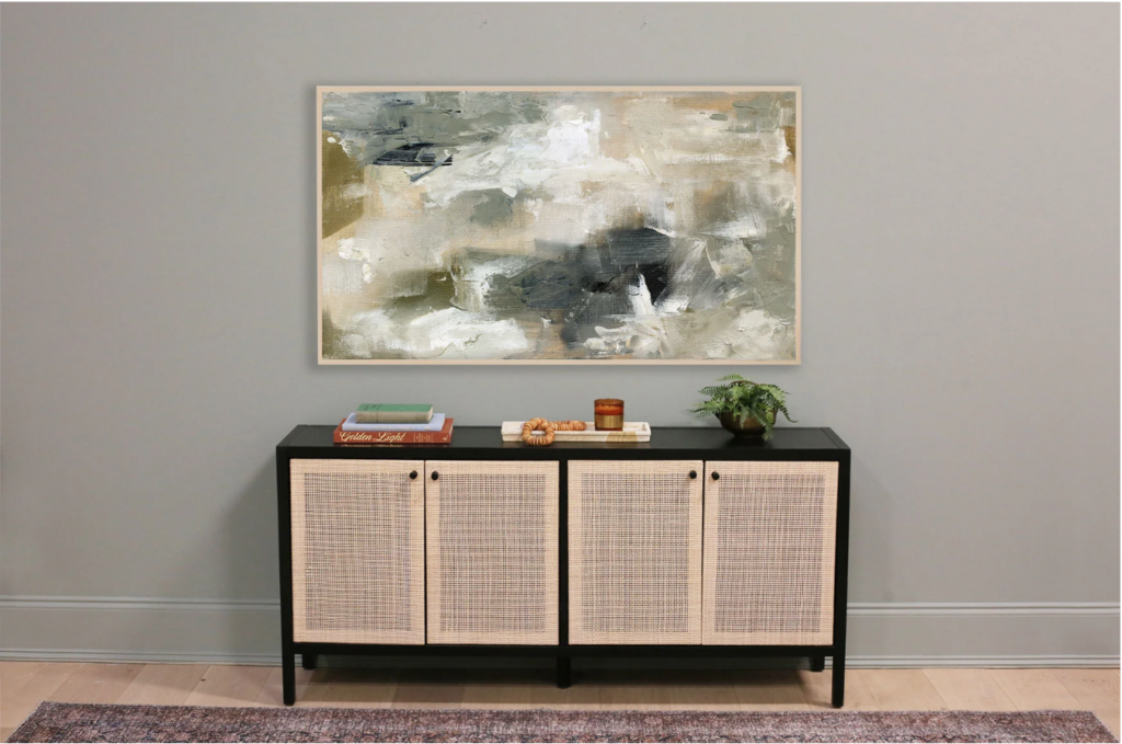 art for tv screen. Image of abstract art with brush strokes in green, blue, tan, and white on grey-green wall over black and tan credenza with red vintage rug in front.