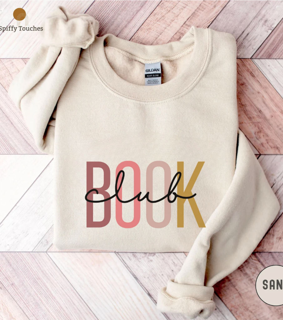 Sand color sweatshirt that says "book club" in different color letters (pinks and yellows). Link provided for purchase.