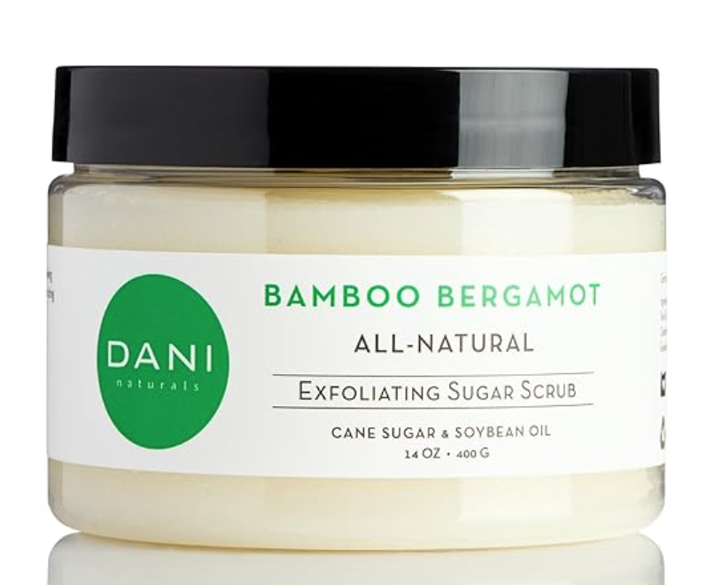 Image of DANI natural exfoliating sugar scrub in bamboo bergamot scent. Clear jar with black lid and white label with green writing.