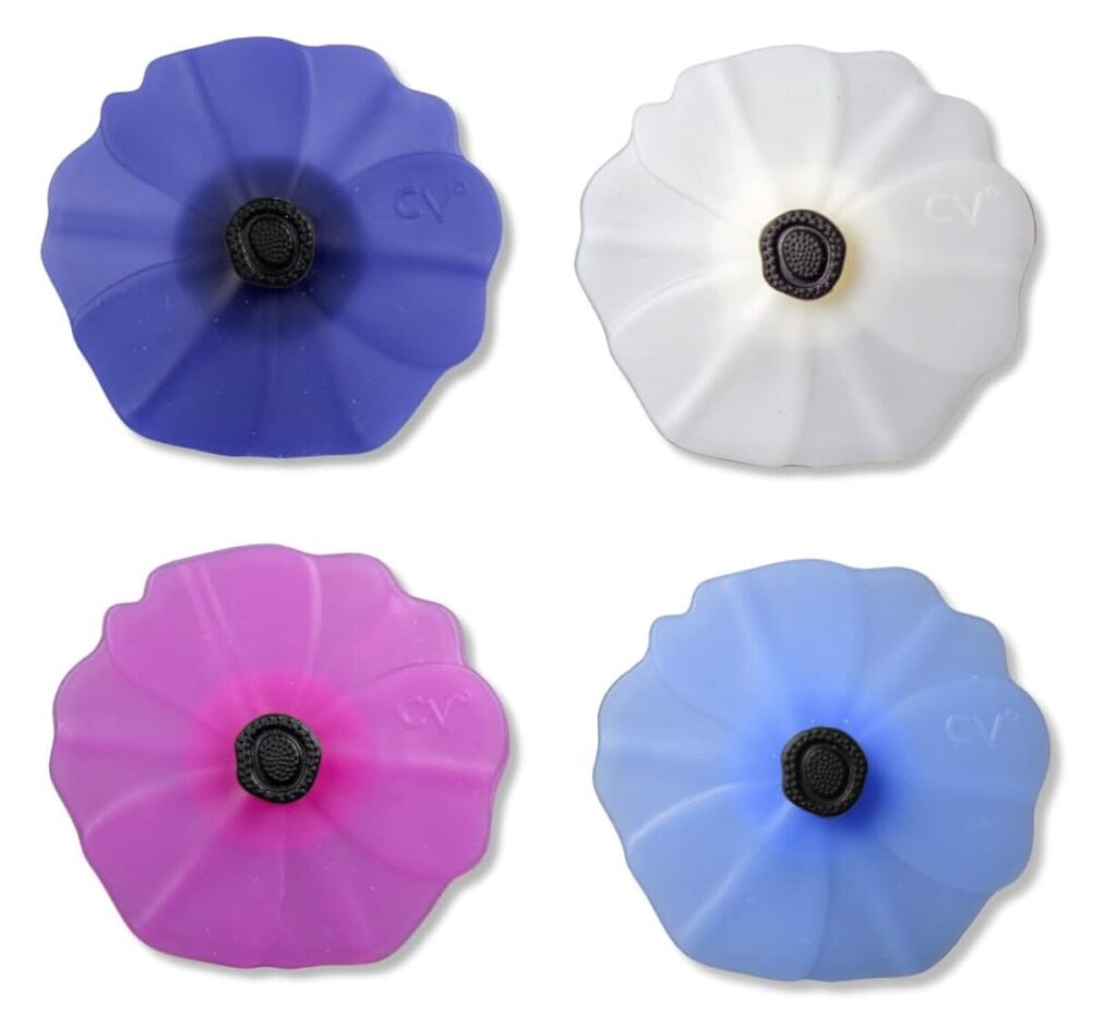 four flower silicone wine stoppers in blue, white, pink, and cornflower blue.
