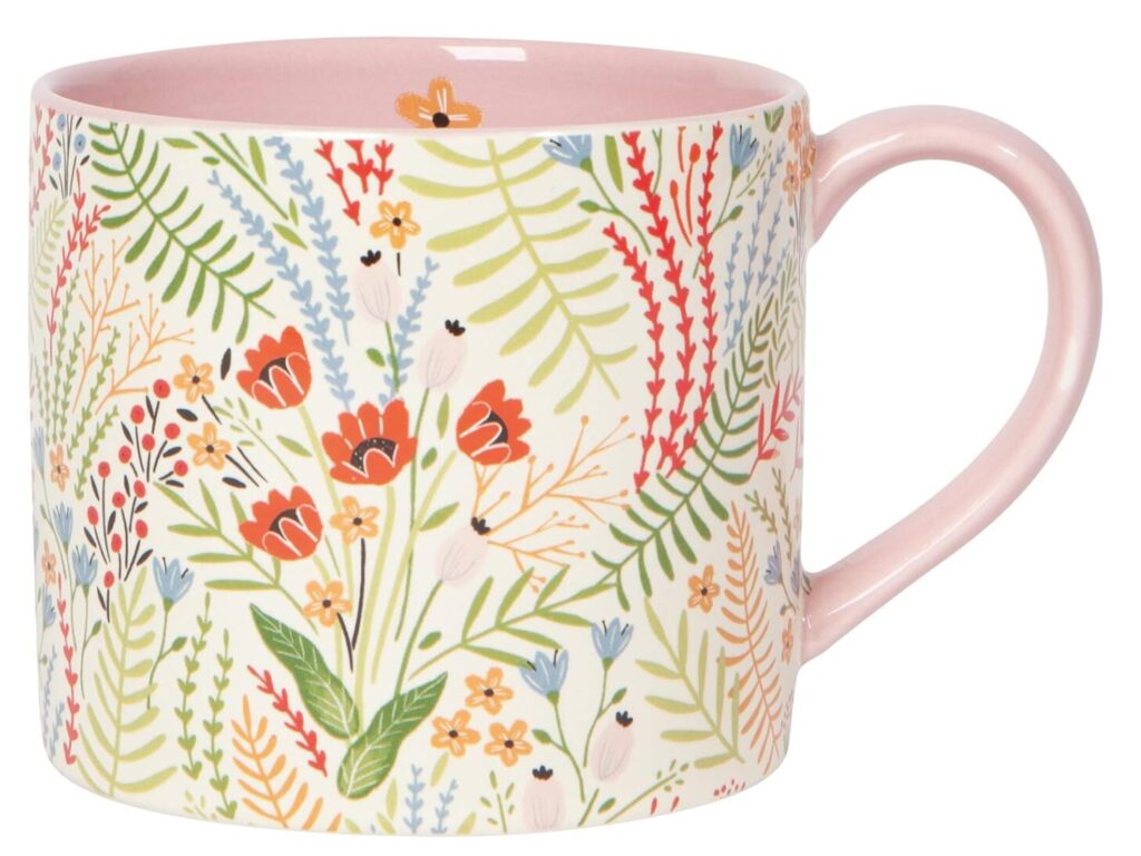ideas gifts hostess. Image of coffee mug with a variety of colors of flowers and pastel pink handle. 