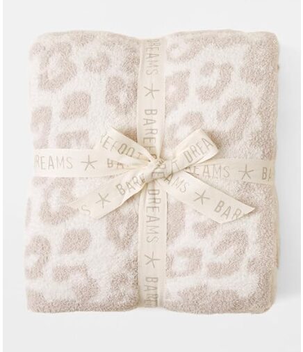 best gifts for women. Image of white and pink leopard print throw blanket, folded and tied with cream bow.