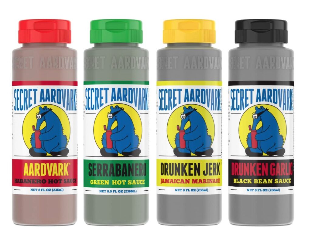 what to get a host. Image of 4 bottles of Secret Aardvark hot sauce in habanero, green, jamaican, and black bean sauce with red, green, yellow, and black labels. 