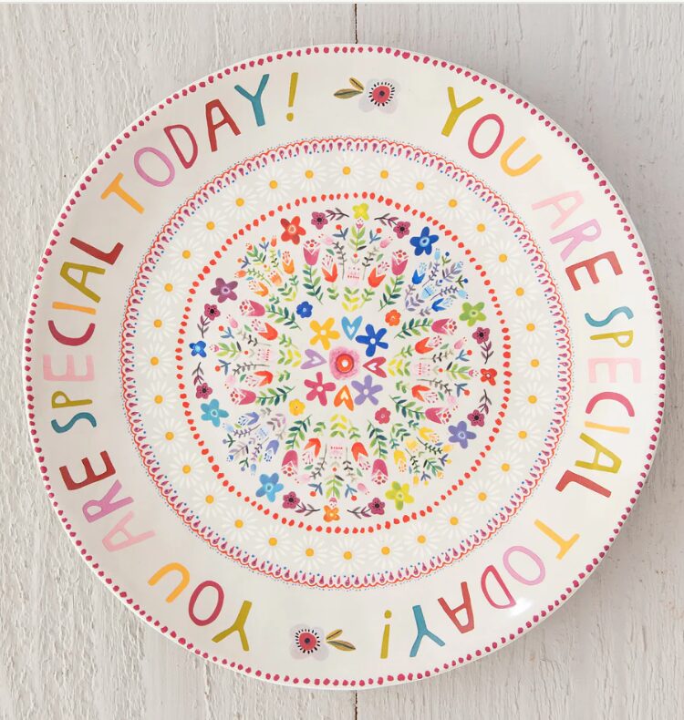 Birthday traditions. Image of "You are special today" written in rainbow colors with flower platter. 