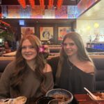 tips for having meaningful conversations with kids. Image of two teen girls at restaurant.