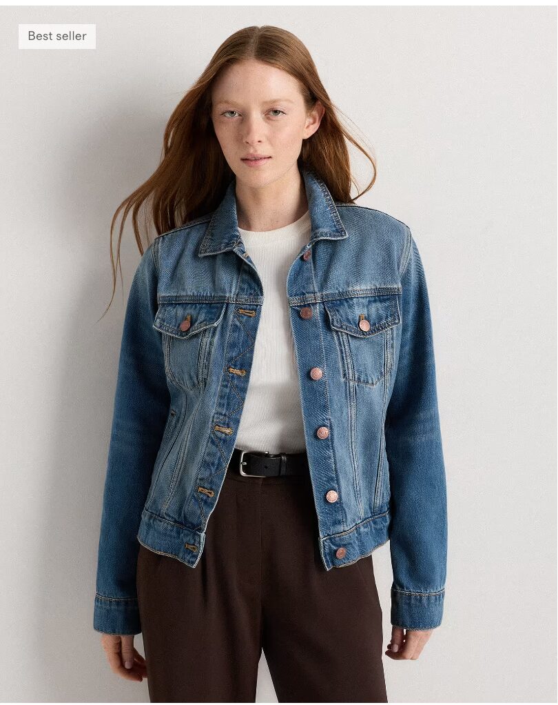 Woman wearing 100% Organic Cotton Denim Jacket with white ribbed shirt and black pants. 