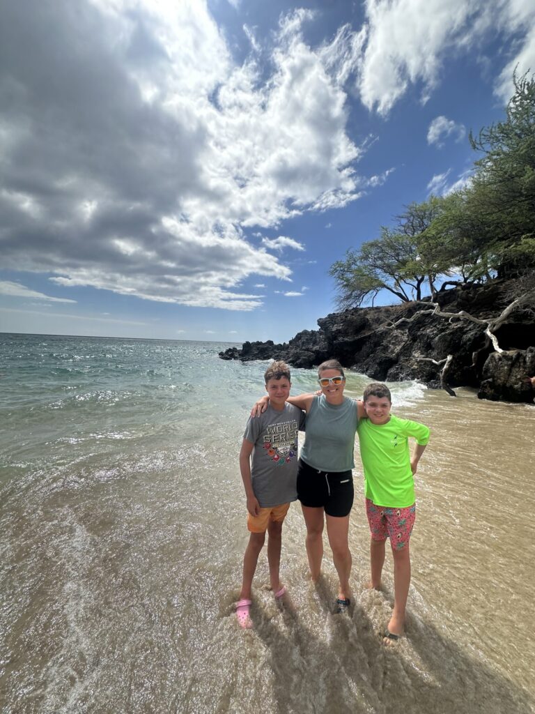 everyday motherhood. Image of mom and two boys on beach in Hawaii. 