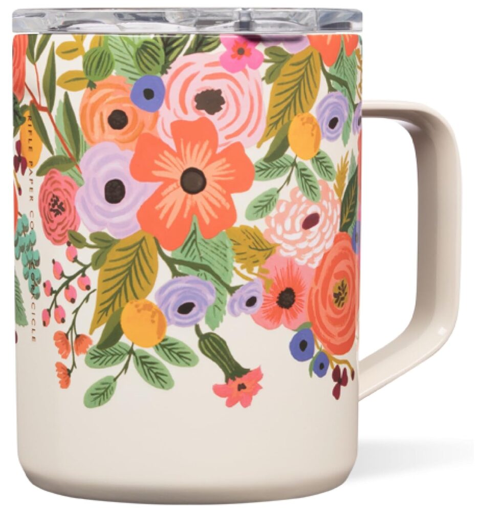 favorite things. Image of to go coffee mug with handle, painted cream with colorful flowers.