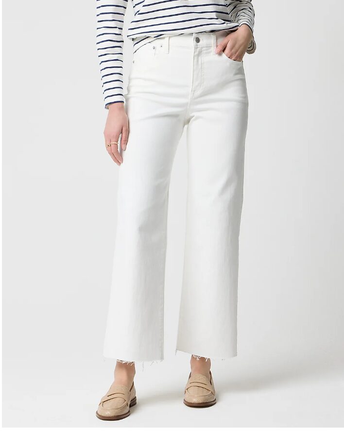 teacher outfit jeans. Woman wearing white cropped denim jeans with a black and white stripe long sleeve and sand-colored loaferes.